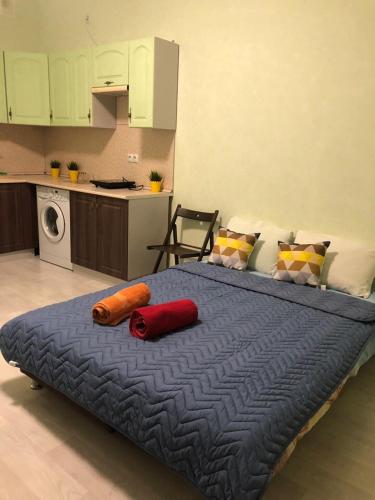 a large bed with two pillows on it in a kitchen at Улица Склизкова д116 к.6 in Tver