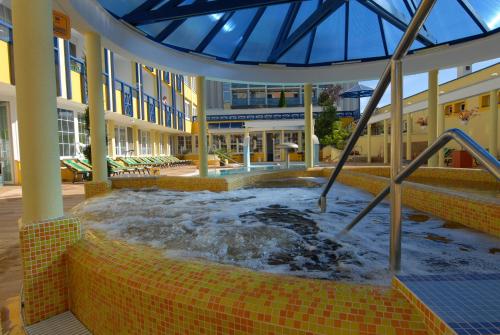 a hot tub in the middle of a building at Hotel Rudolf in Hajdúszoboszló