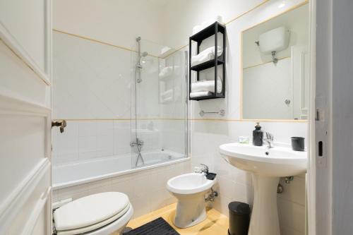 a white bathroom with a toilet and a sink at Fleming 58 by Hili in Rome