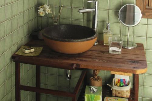 a sink on a wooden table in a bathroom at Molí del Casó B&B in Bagá