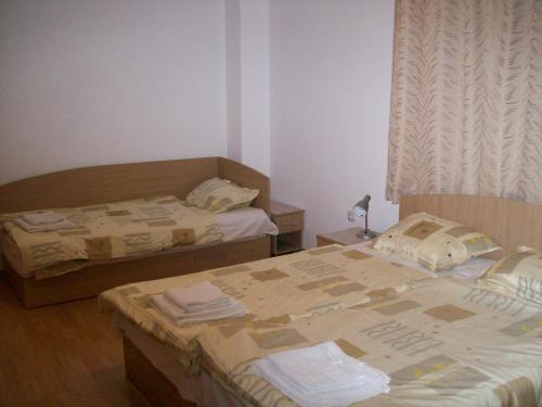 a bedroom with two beds and a window at Guest House Donchevi in Primorsko