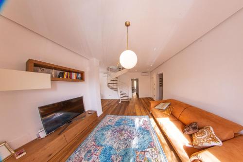 un soggiorno con divano e TV di Figoli guesthouse a Oristano