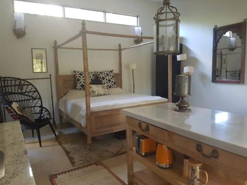 a bedroom with a canopy bed and a table at Mt Lofty Botanic Garden Studio in Crafers