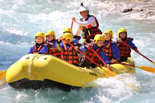 a group of people in a raft in the water at SOWELL HOTELS Le Parc & Spa in Briançon