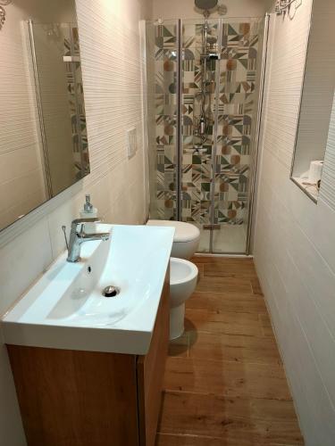 a bathroom with a sink and a toilet and a shower at la morra in Viterbo