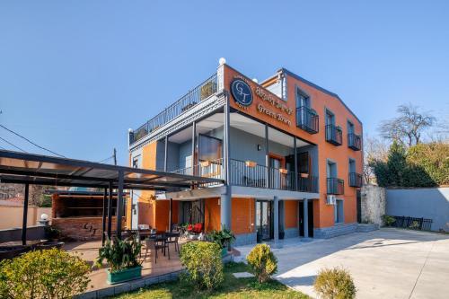 an exterior view of a building with a patio at Hotel Green Town in Kutaisi