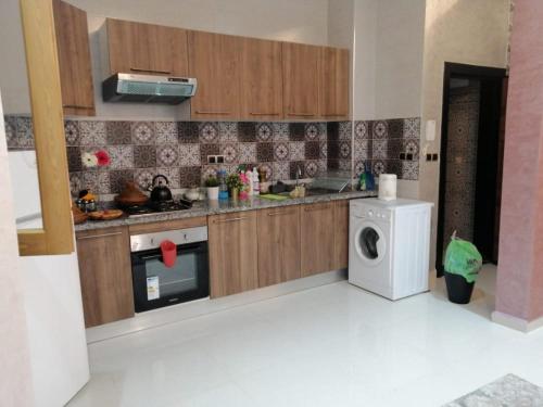 a kitchen with a washing machine and a washer at Joli appartement Casablanca ain sebaa in Casablanca
