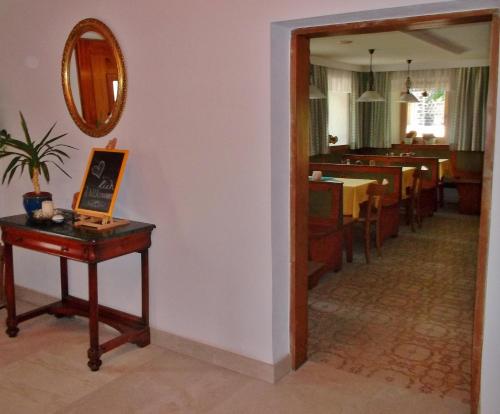 a hallway with a table and a dining room at Gasthof-Pension Zum Haugstein - Familie Eder in Engelhartszell