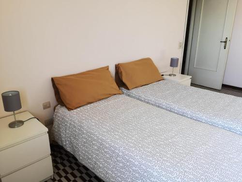 a bedroom with a bed with two pillows on it at B&B DE CAROL in Gramignazzo