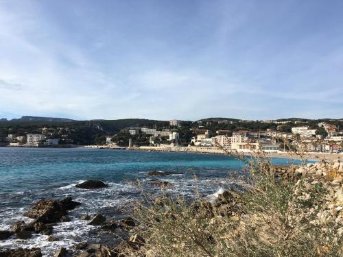 a view of a beach with buildings in the distance at BOUTIQUE HOSTEL BY Cassis in Cassis