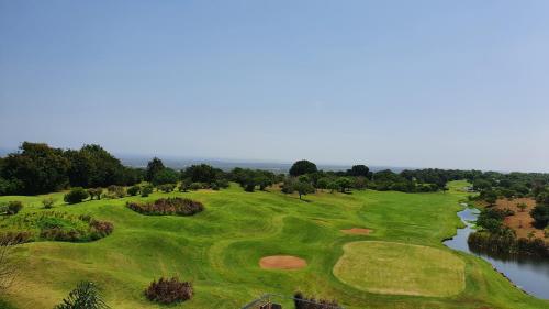 an aerial view of a golf course with a river at Vipingo Ridge-Swahili Villa in Mombasa