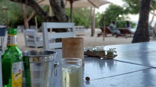 a table with a bottle of beer and a bucket of water at Vipingo Ridge-Swahili Villa in Mombasa
