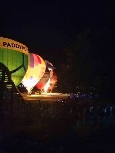 a hot air balloon is lit up at night at Zhiben hotspring Heping Guesthouse in Wenquan