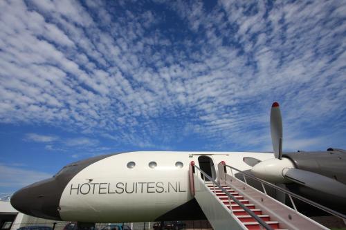an airplane is parked on the tarmac with a sky at Vliegtuigsuite Teuge in Teuge