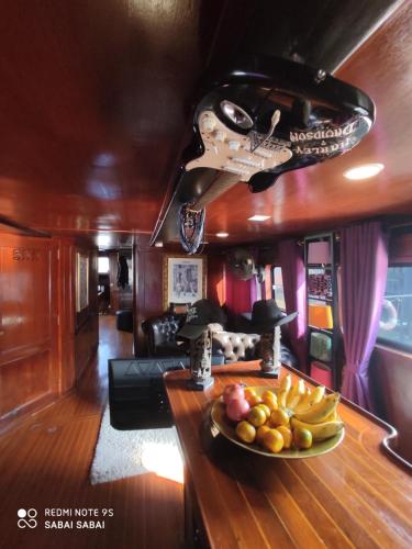 a bowl of fruit on a table in a train room at Sabai Sabai Liveaboard Bangkok in Bangkok