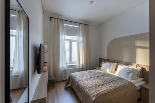 מיטה או מיטות בחדר ב-Laisves ave. Apartments Mini