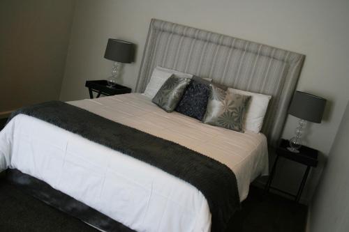 a bedroom with a large white bed with pillows at Goulden Street Guest House in East London