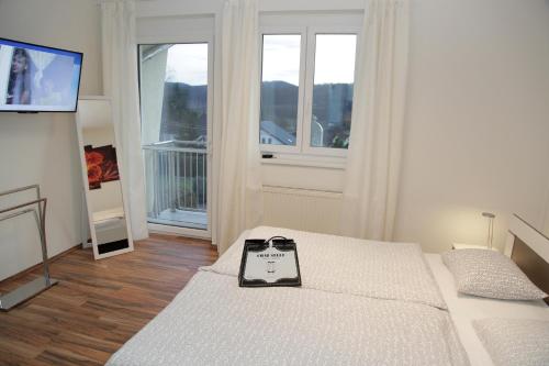 a small bedroom with two beds and a television at Ferienwohnungen Kres in Gamlitz