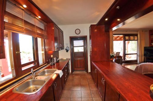 a kitchen with two sinks and a counter top at Postatiko Holiday Home Central Corfu in Kynopiástai
