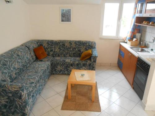 a living room with a couch and a table at Apartments Špadina in Tisno