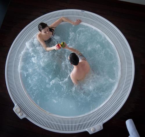 two men in a pool of water at Hotel Kaj in Marija Bistrica