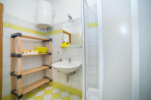a bathroom with a sink and a mirror at Apartments Grulović in Srima