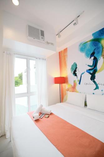 a bedroom with two beds and a painting on the wall at La Bella Boutique Hotel in Tagaytay