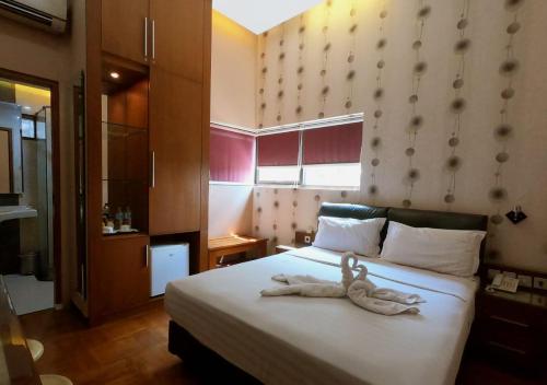 Postel nebo postele na pokoji v ubytování Omah Qu Guesthouse Malioboro