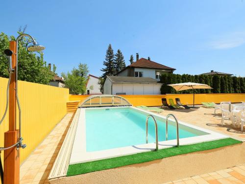 a swimming pool in the backyard of a house at Apartment Amarillo 3-5 by Interhome in Balatonkeresztúr