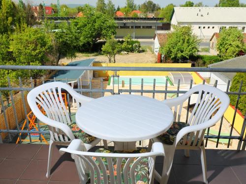 a white table and chairs on a balcony with a pool at Apartment Amarillo 3-5 by Interhome in Balatonkeresztúr