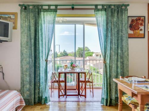 a room with a table and a large window at Apartment Plein Soleil-1 by Interhome in Cap d'Agde