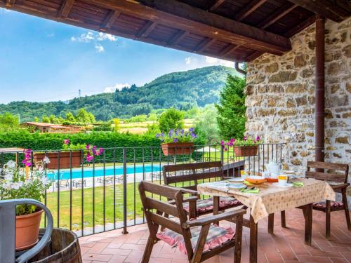 a patio with a table and chairs and a pool at Holiday Home La Fenice by Interhome in Vitoio