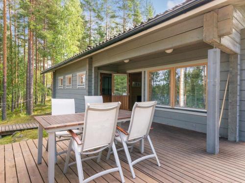 a wooden deck with a table and chairs on a house at Holiday Home Hot pool cottage ainu by Interhome in Ihamaniemi