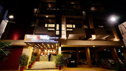 a building with a sign in front of it at night at New Hotel Suhail in Hyderabad