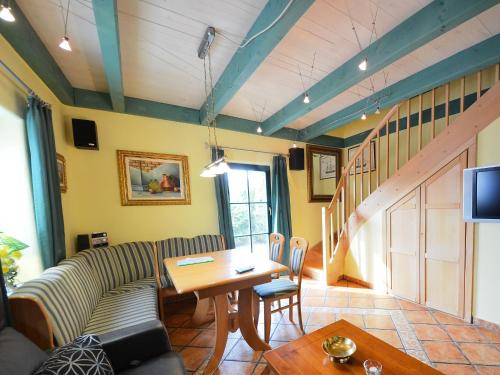 a living room with a couch and a table at Holiday Home Kapitänshaus by Interhome in Groß Zicker