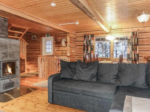 a living room with a couch and a fireplace at Holiday Home Ylikyrön mökki by Interhome in Kyrö
