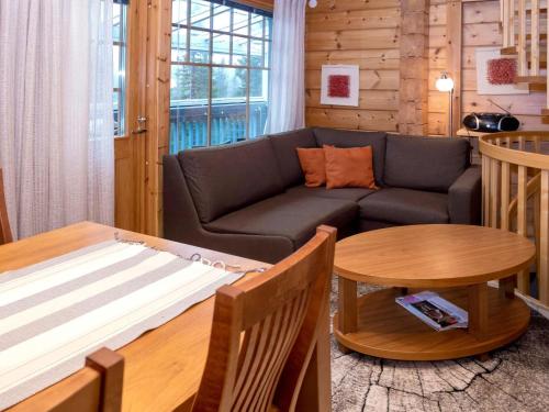 a living room with a couch and a table at Holiday Home Vuosselin trio b by Interhome in Ruka