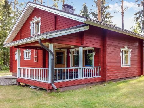 Juhanala的住宿－瓦特拉卡維洛瑪克斯庫度假屋，一间红色的小房子,有白色门廊