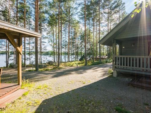 una casa con un porche junto a un bosque en Holiday Home Kuvalanranta by Interhome, en Mouhu