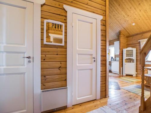 a door in a room with wooden walls at Holiday Home Mäntykumpu by Interhome in Petäjävesi