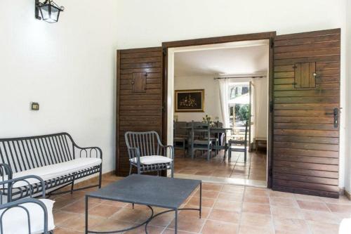a living room with a couch and chairs and a table at Villa Biancospini - guesthouse Le Case di Aurelia in Castellaneta Marina 