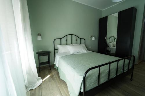 a bedroom with a large bed with white pillows at La nuova Coccinella in Bra