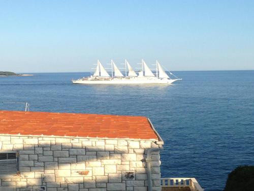 a large boat with white sails in the water at Apartment Paco in Dubrovnik