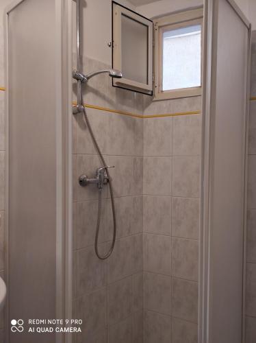 a shower in a bathroom with a window at Dimora dell'Isola Gallipoli in Gallipoli