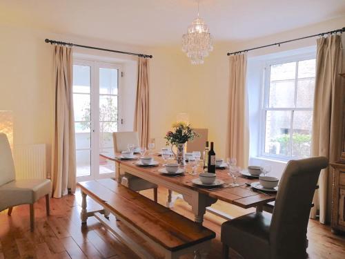 ein Esszimmer mit einem Holztisch mit Stühlen und einem Esszimmer in der Unterkunft Cornwall, Looe - Magical Pendriffey in Pelynt