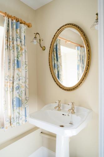 a bathroom with a sink and a mirror at The South Wing in Salisbury
