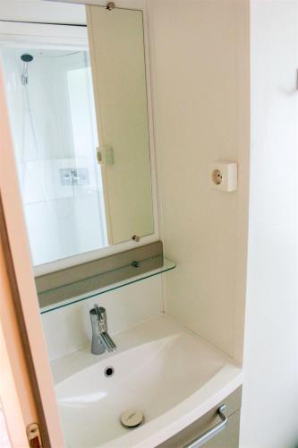 a bathroom with a sink and a mirror at Holiday Home Hawaii Style by Interhome in Prague