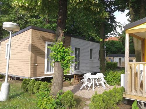 a tiny house with a table and chairs in front of it at Holiday Home Hawaii Style by Interhome in Prague
