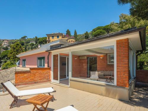 a house with a patio with a bench and a table at Apartment Casa del Leone II by Interhome in Rapallo