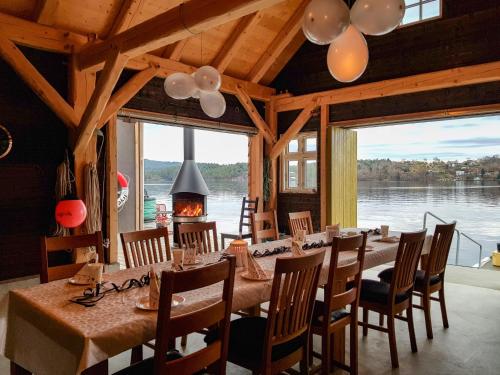 een eetkamer met tafels en stoelen en een groot raam bij Holiday Home Strøneneset - FJH231 by Interhome in Hagavik